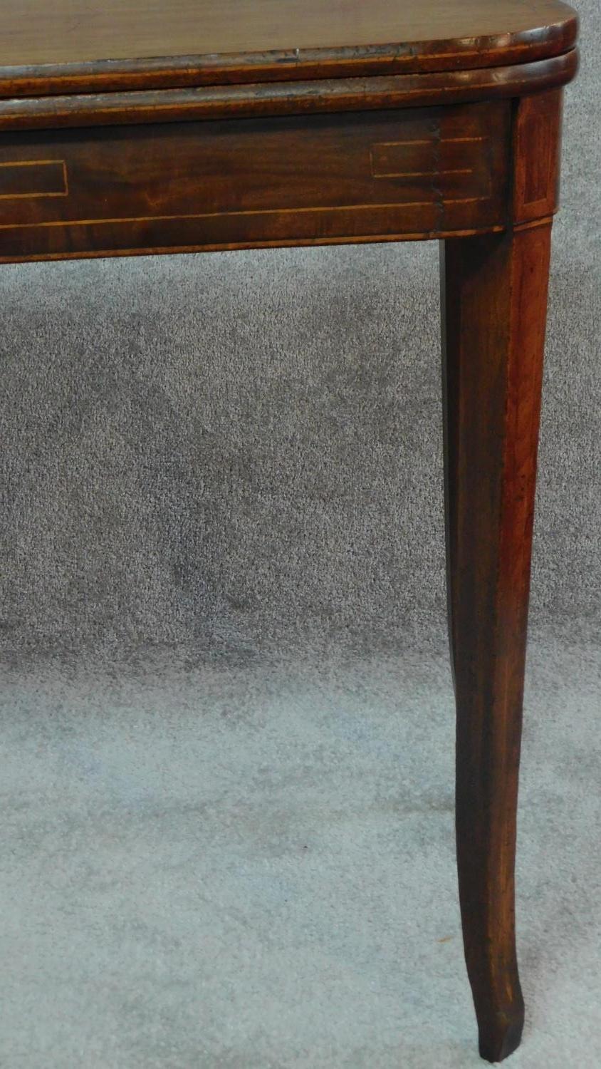 An early 19th century mahogany inlaid flap top tea table on tapering sabre supports. H.72 W.90 D.91 - Image 3 of 6