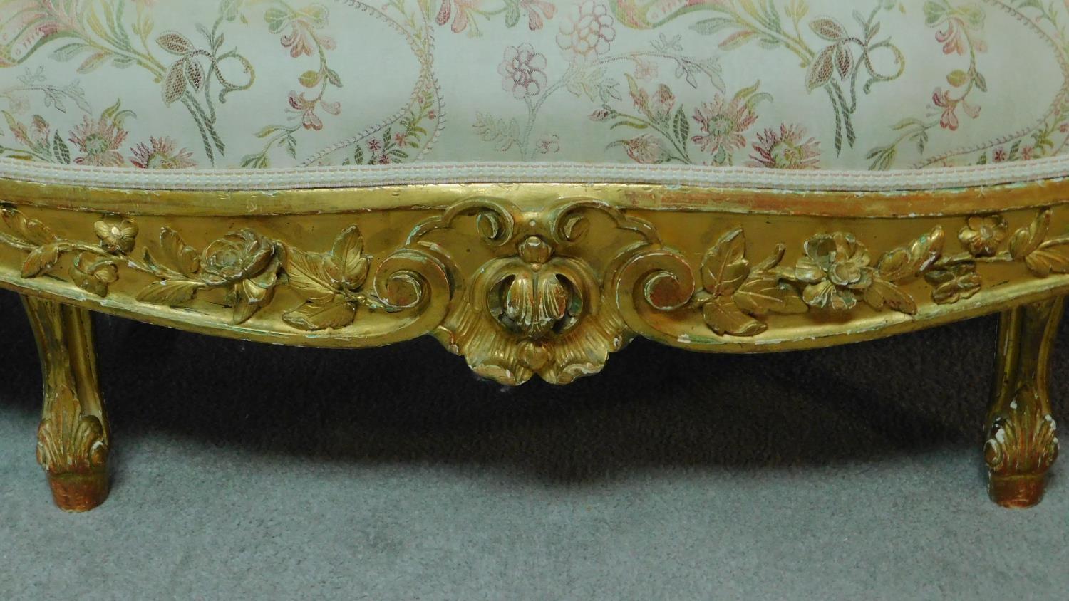 A 19th century rococo style giltwood three seat canape with shell carved cresting back rail and - Image 7 of 10