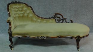 A Victorian carved mahogany framed chaise longue in sage buttoned upholstery on cabriole supports