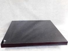 A very low square topped black lacquered coffee table. H.20 W.150 D.150cm