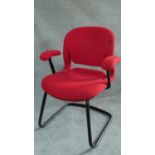 A Herman Miller metal framed office armchair in red upholstery. H.84cm