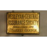 A collection of three brass wall plates for the Weslyan and General Assurance society.