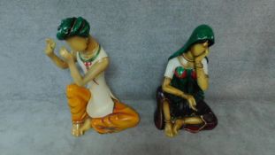 An unusual pair of male and female fibreglass Indian mannequins both playing musical instruments