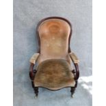 A Victorian mahogany framed scroll armchair on turned tapering bulbous supports. H 106 cm