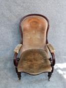 A Victorian mahogany framed scroll armchair on turned tapering bulbous supports. H 106 cm