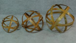 Three hinged iron work spheres, graduating in size. H.44 (tallest)