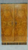 An Art Deco burr walnut and zebra wood inlaid press cupboard fitted with linen drawers. H.124 W.77