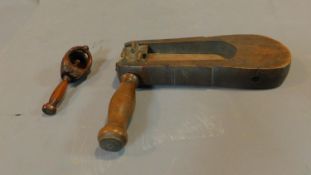 A vintage wooden bird scarer and a carved treen squirrel nutcracker