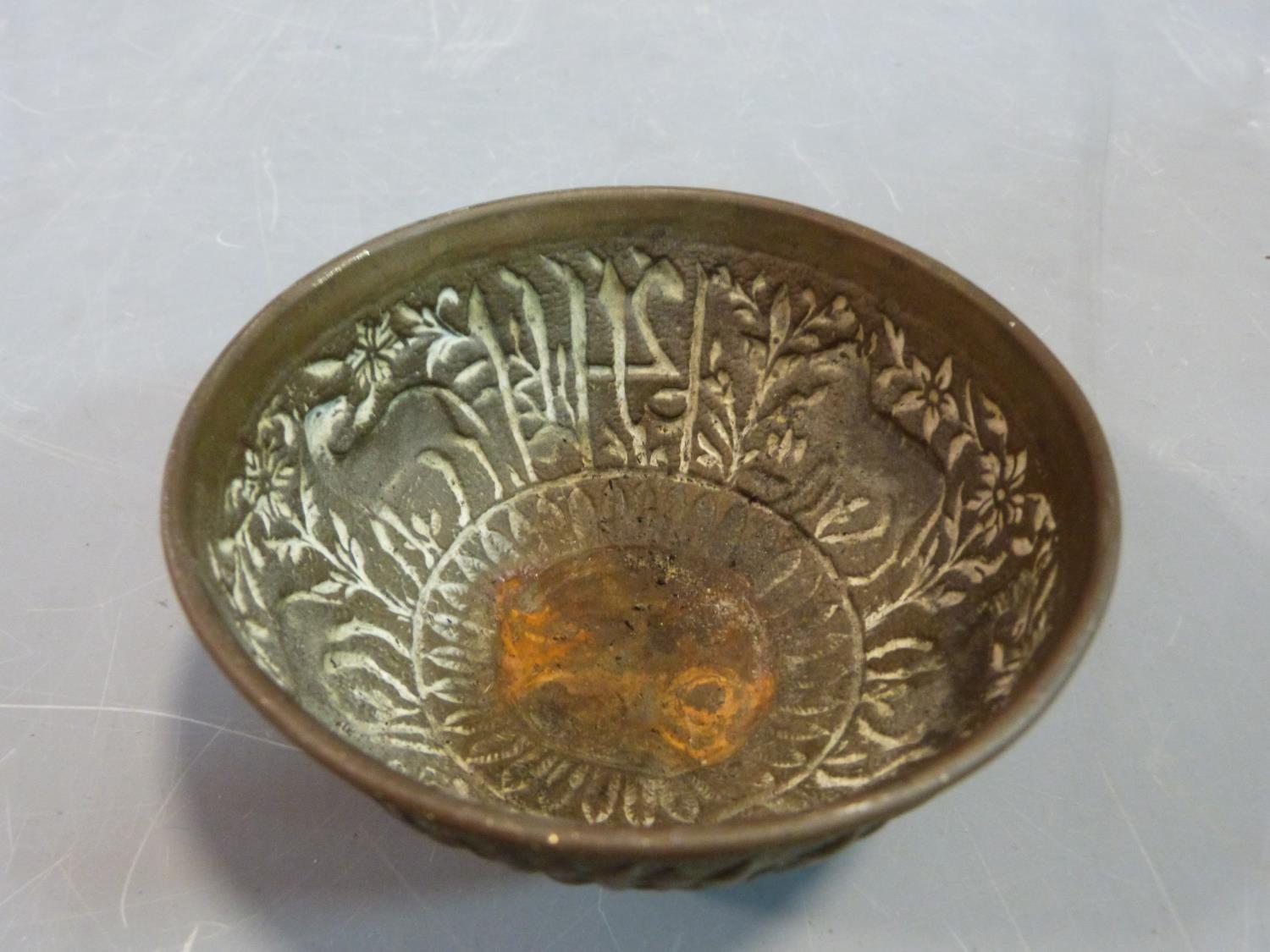 A tribal wooden foot carving and an Indian brass bowl with repousse animal design and a wooden stand - Image 6 of 10