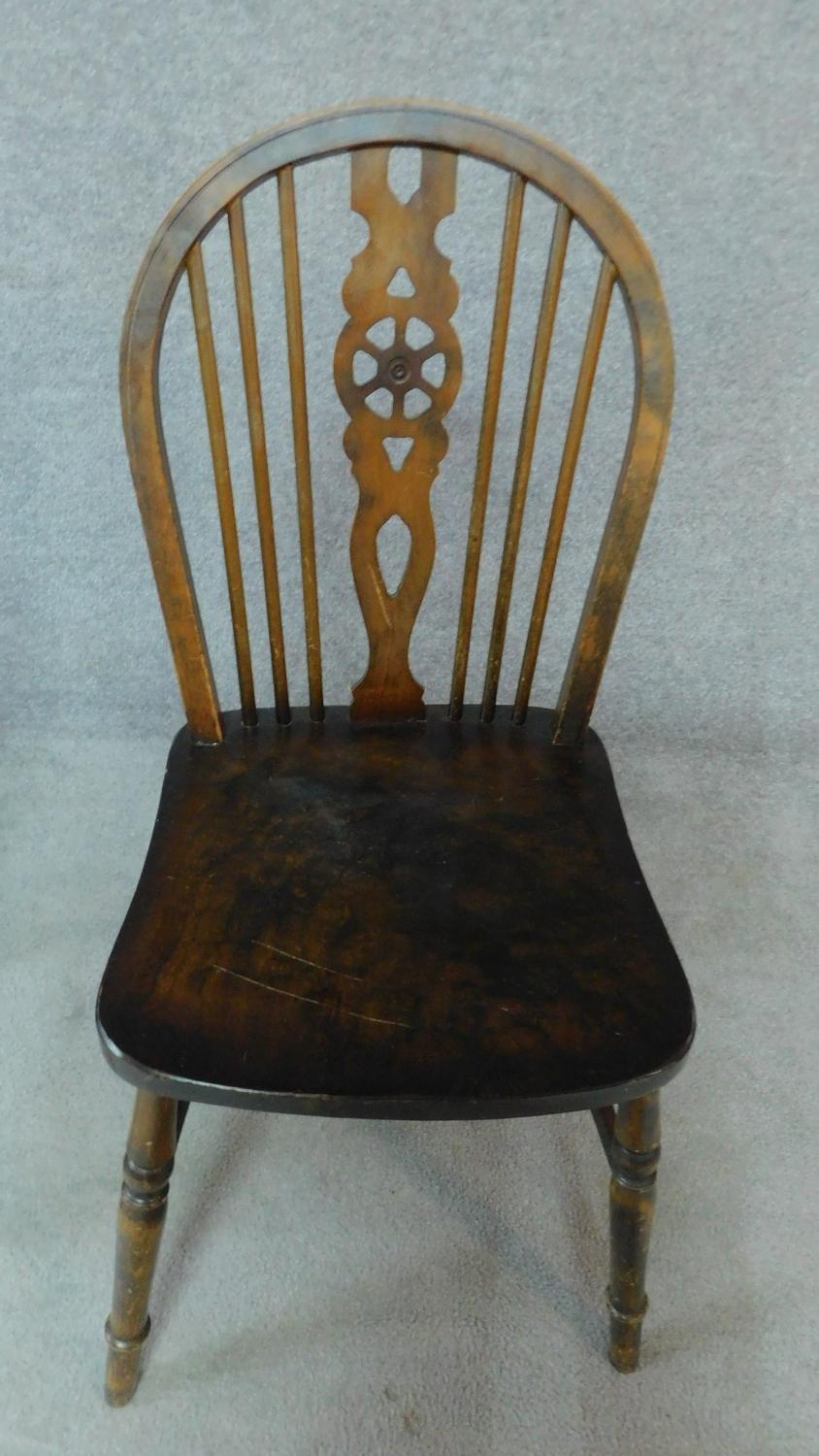 A 19th century elm ladderback dining chair and an elm seated Windsor wheelback chair. H.93cm - Image 5 of 7