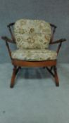 A mid 20th century stained beech Ercol style armchair. H.84cm