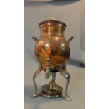 A copper kettle and hot water urn with burner below. H.35cm
