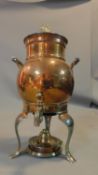 A copper kettle and hot water urn with burner below. H.35cm