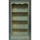 A distressed painted open bookcase on plinth base. H.121 W.60 D.22cm