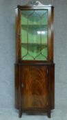 A Georgian style mahogany and satinwood inlaid corner cabinet. H.184 W.67cm