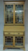 An Edwardian mahogany bureau bookcase with astragal glazed upper and lower sections and fall front