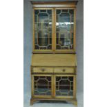 An Edwardian mahogany bureau bookcase with astragal glazed upper and lower sections and fall front