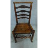 A 19th century elm ladderback dining chair and an elm seated Windsor wheelback chair. H.93cm