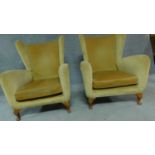 A pair of vintage gold velour wingback armchairs on squat beech cabriole supports. H.94cm