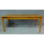 A 19th century pine/Yellowwood planked top refectory dining table on turned tapering supports. H.