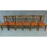 A set of six Anglo Indian teak dining chairs with pierced splat backs. H.96cm