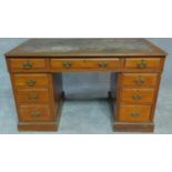 A late Victorian walnut three section pedestal desk with original inset leather top fitted