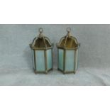 A pair of brass hanging storm lanterns with light bulbs. Stamped to the back Lamp Art, Dept. H.50cm