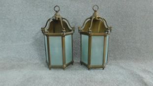 A pair of brass hanging storm lanterns with light bulbs. Stamped to the back Lamp Art, Dept. H.50cm