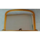 A Victorian style pine arched overmantel mirror. 81x126cm