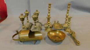 A collection of brass items including two pairs of candlesticks, a trench art miniature coal scuttle