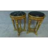 A pair of Empire style gilt jardiniere stands with circular grey veined marble tops. H. 85cm D. 54