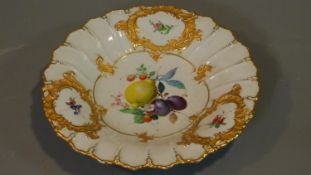 A Meissen handpainted and gilded fruit plate, with central cartouche depicting a lemon, plum,