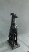 A large metal figure of a seated hound with gold collar and painted features, . H.81cm