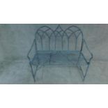 A metal garden bench with triple Gothic arched back. H. 100cm W 102cm D. 48cm