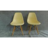 A pair of moulded lemon tub chairs on beech hairpin supports. H.83cm