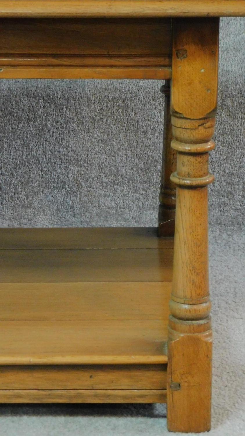 A pair of antique style country oak side tables on turned supports united by undertier. H.50 W.61 - Image 2 of 5
