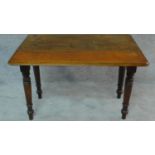 A Victorian mahogany drop flap pembroke table on turned tapering supports. H.65 W.89 D.59cm