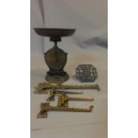 An antique brass weighing scale and other brass items and a collection of brass wall mounted