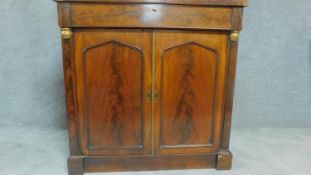 A Regency mahogany two door chiffonier with arched panel doors flanked by pilasters. H.92cm W.92cm