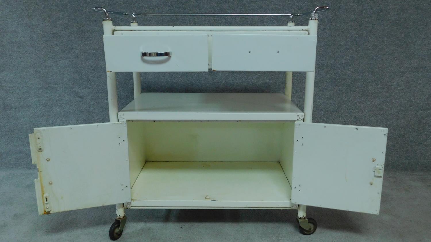 A white painted and metal medical cabinet/trolley with drawers and cupboards on casters. H.90 W.86 - Image 3 of 6