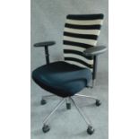 A Vitra swivel adjustable office armchair on chromium castered base. H.101cm