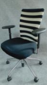 A Vitra swivel adjustable office armchair on chromium castered base. H.101cm