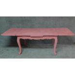A painted French extending dining table on carved cabriole supports. H.75 W.237 D.99cm