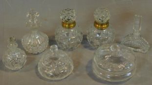 A pair of cut crystal scent bottles with gilt metal collars and a collection of other similar items.