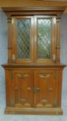 A 19th century Flemish style oak two section bookcase the upper section fitted leaded coloured glass