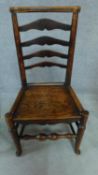 A 19th century elm ladderback dining chair and an elm seated Windsor wheelback chair. H.93cm