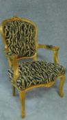 A gilt framed French style fauteuil in leopard print upholstery. H.94cm