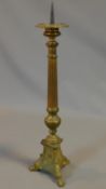 An antique brass Gothic style pricket candle stick. H.61cm