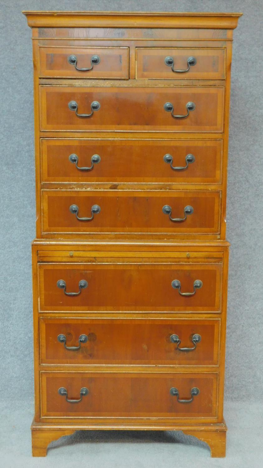 A Georgian style yew chest on chest with two short and six long drawers fitted brushing slide. H.174