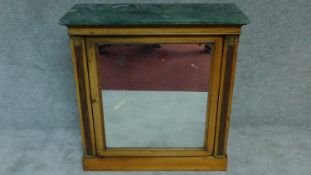 A 19th century Empire style rosewood pier cabinet, the original central plate glass flanked by reed